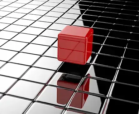 3D rendering of a red cube standing out on a glossy black grid symbolizing leadership and bold strategy